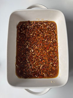 Pecan filling in pan prior to adding rolls