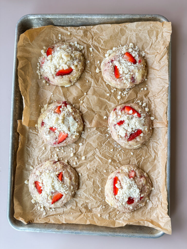 Top cookies with crumble and strawberries after baking 10 minutes