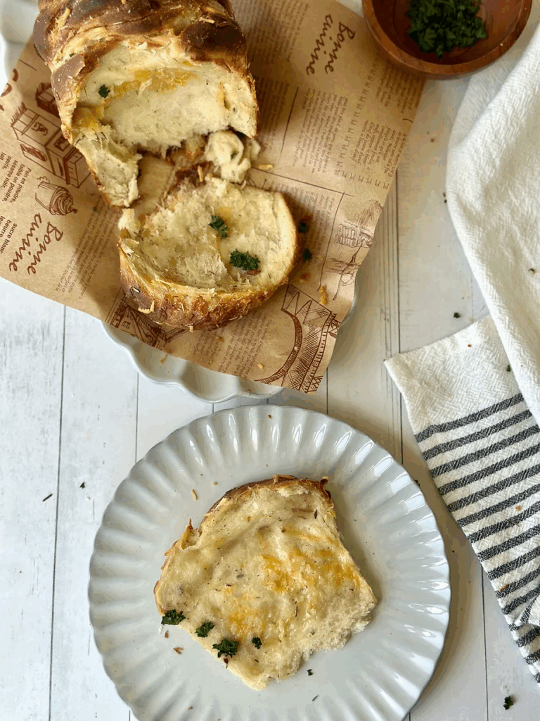 Slice of sourdough garlic rosemary 
cheesy pull-apart loaf
