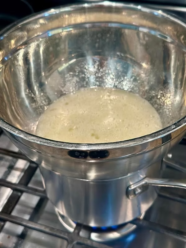 Heat egg whites in a bowl over simmering water until it reaches 160-170 F