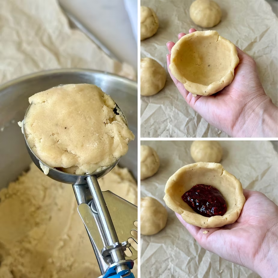 Scoop and make bowls out of your cookie dough then fill with jam and close
