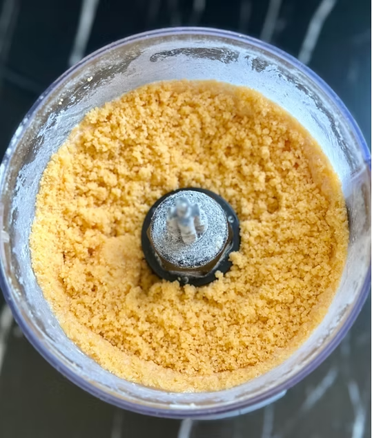 Pulse cheese and butter until crumbly mixture forms.