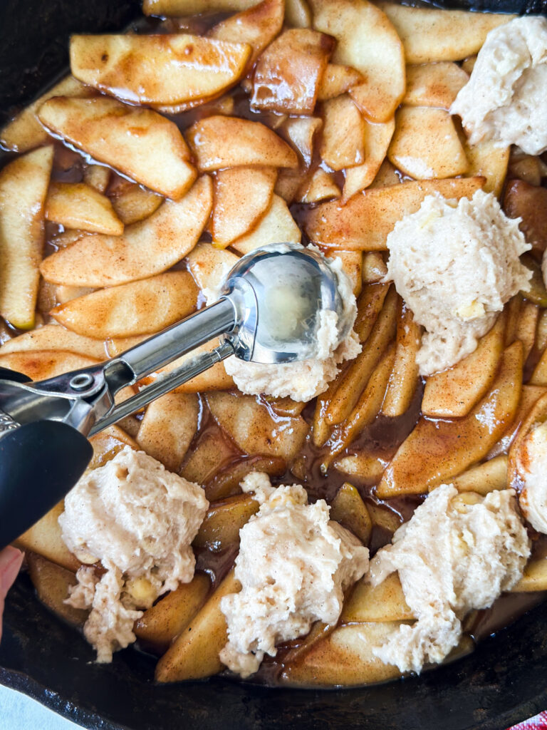 Add rounded Tablespoons scoops of biscuit batter to the top of filling