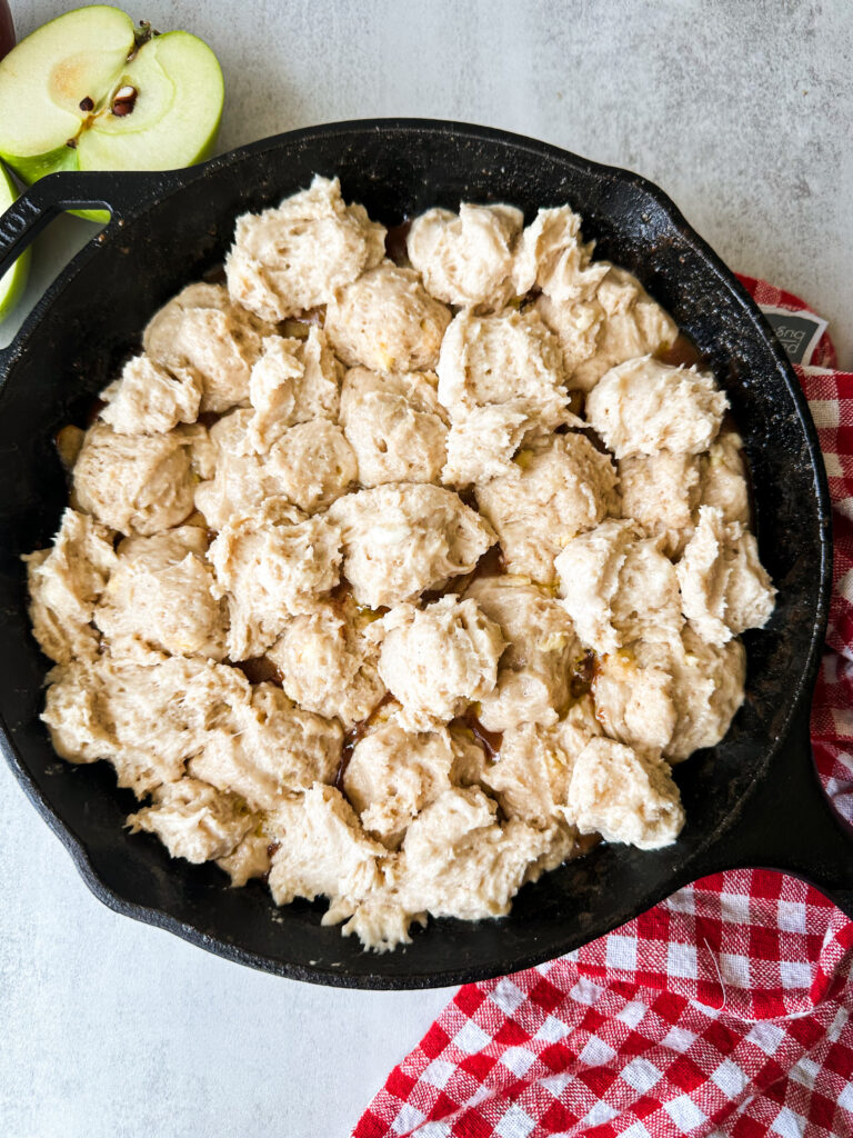 Cover the top of the cobbler with biscuit dough