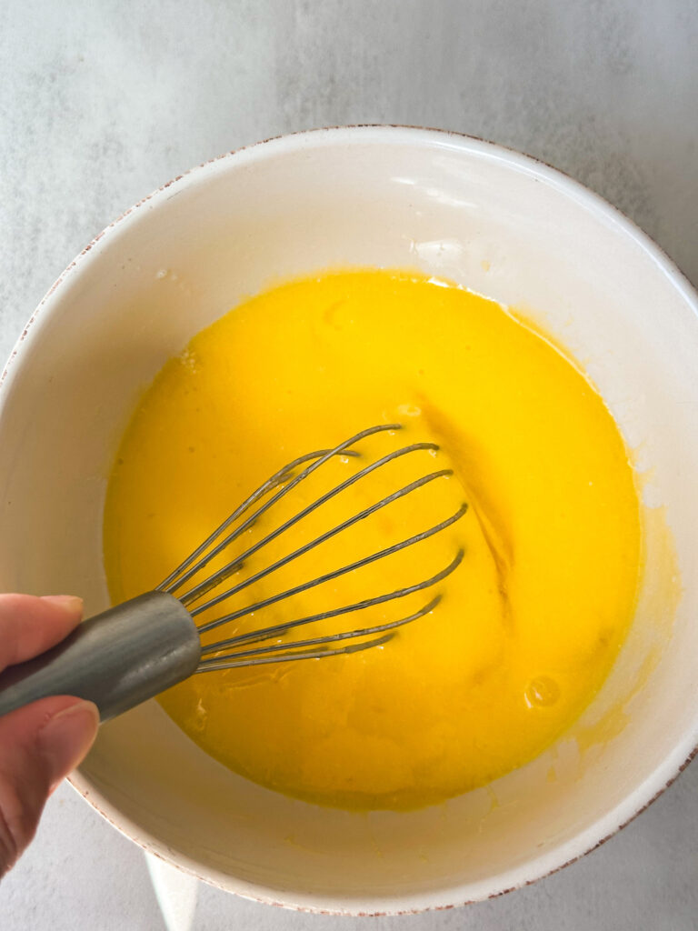 Whisk eggs and butter to form an emulsion.