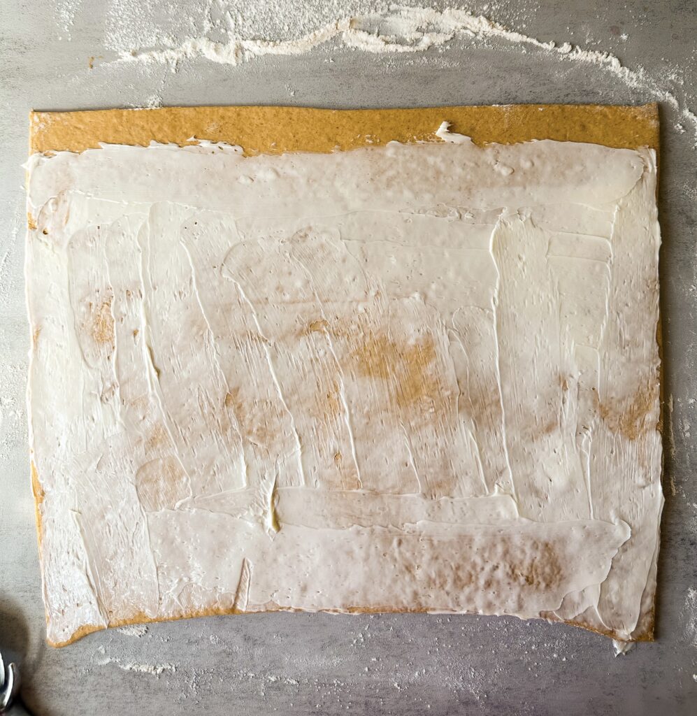 Cover dough with butter leaving a top border of 1/2 inch