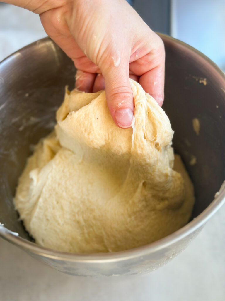 Dough should be tacky and smooth; it won't pass windowpane that's okay