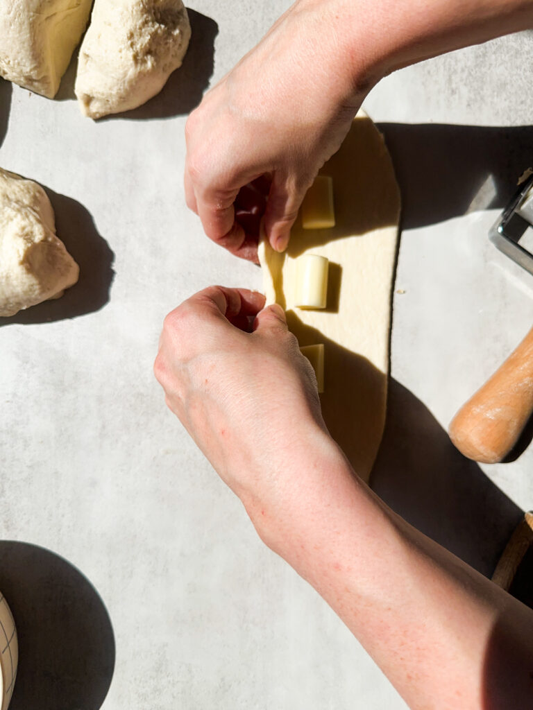Start rolling up the dough from the long edge 