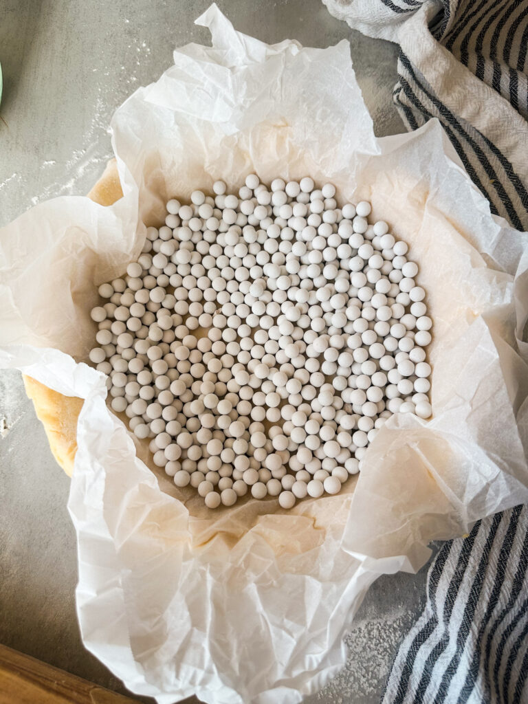 Add the pie weights to the parchment lined pie crust