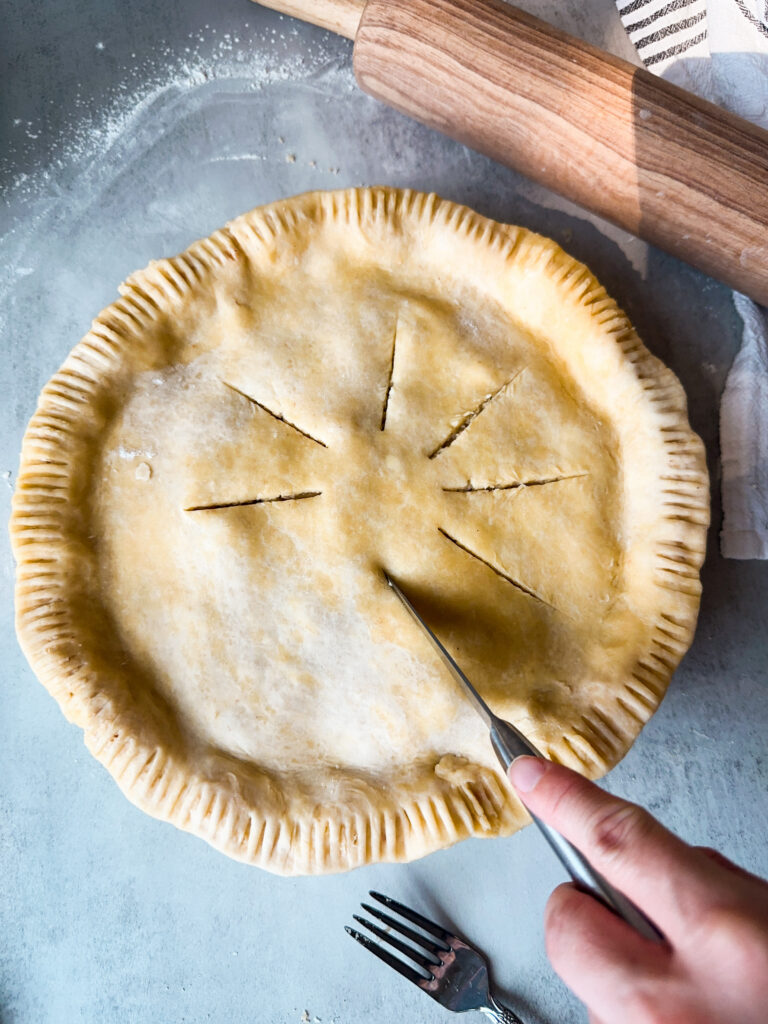 Cut vents in a circular shape around the pie