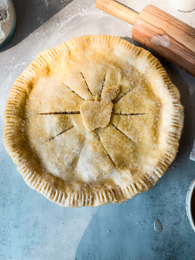 Brush the pie with egg wash and add coarse sugar