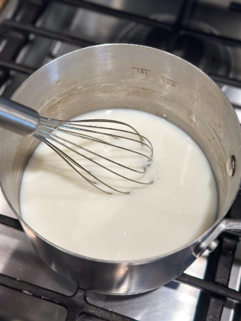 Heat milk and water together