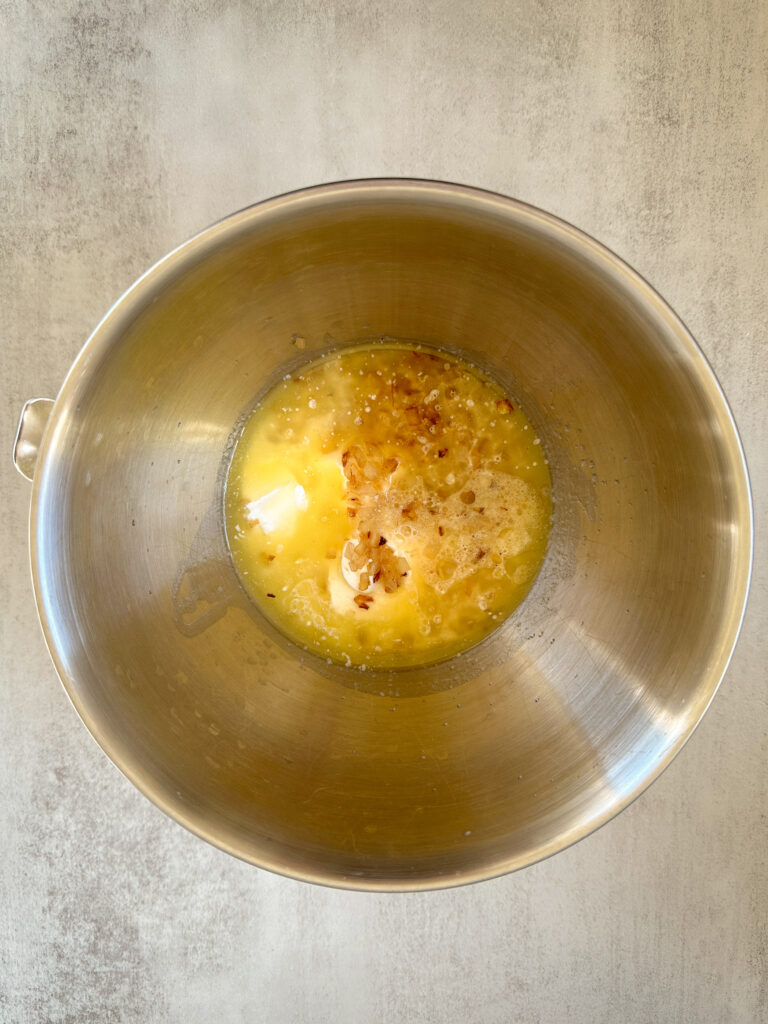 add the sour cream, melted butter, egg yolk, water, and caramelized onions