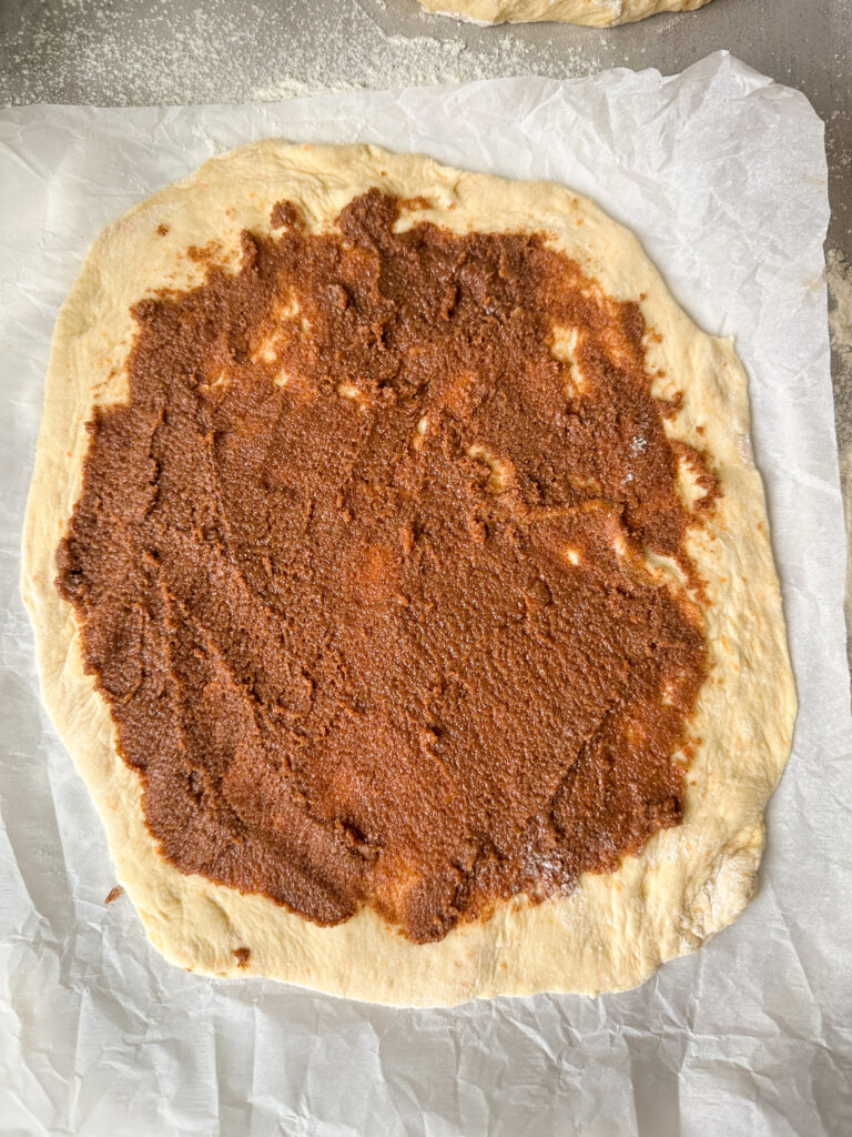 Roll out the 1st dough ball and spread with half the cinnamon sugar paste