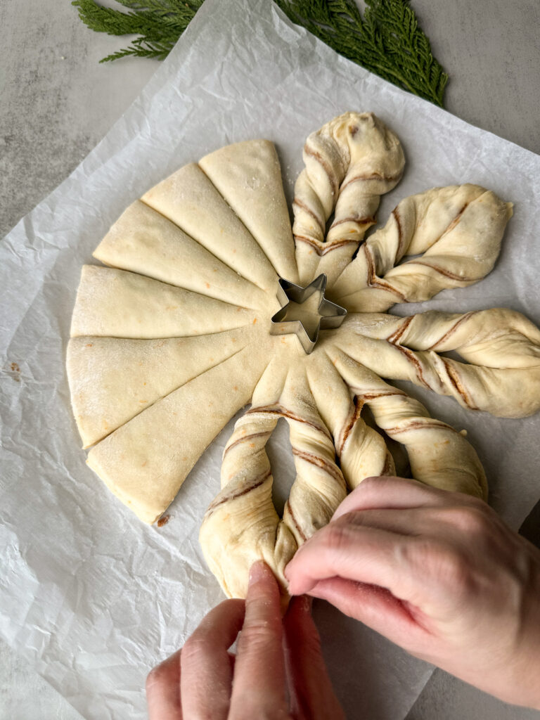 Then pinch then ends together and tuck to form one star point