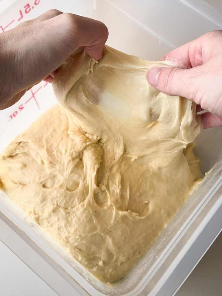 Dough should be tacky and smooth; it won't pass windowpane that's okay