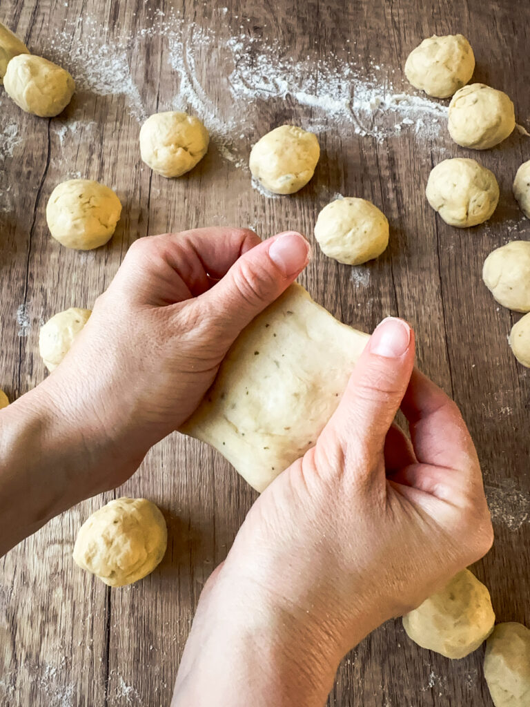 Flatten the ball with your thumbs
