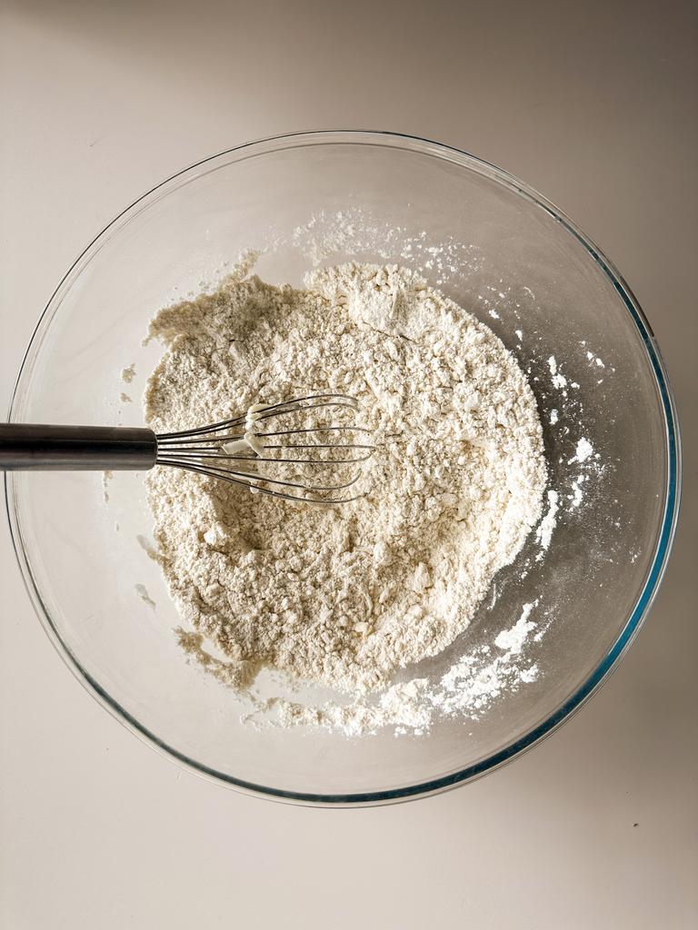 Mix butter bits into dry ingredients 