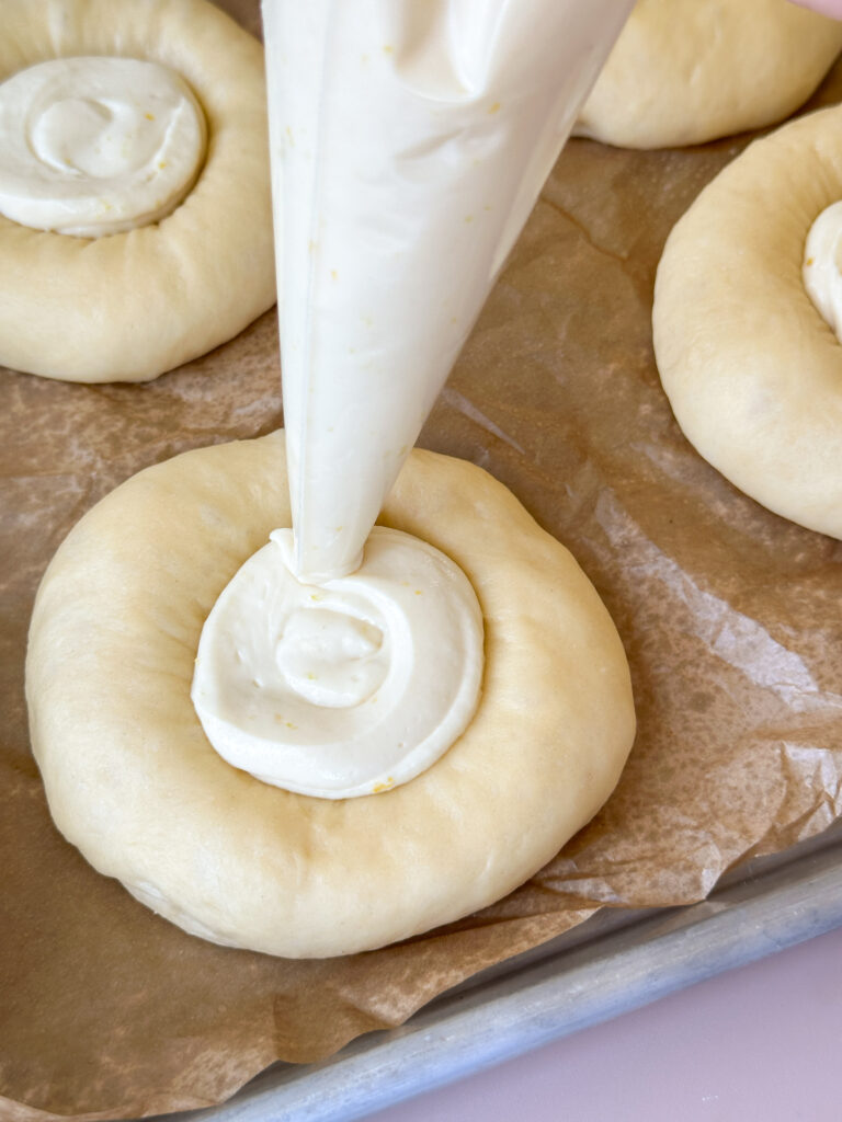 Pipe the cream cheese filling into the centers of the buns